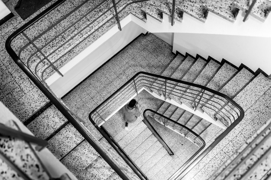 a black and white photo of a spiral staircase