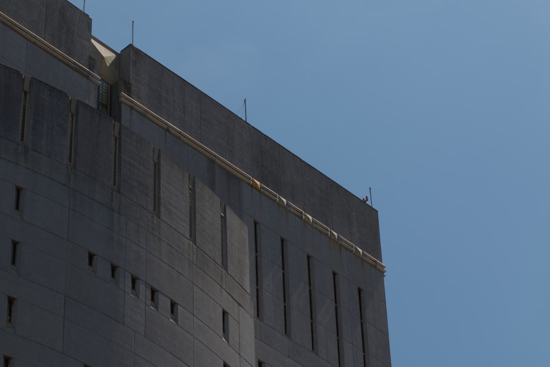 A concrete building against a clear blue sky.