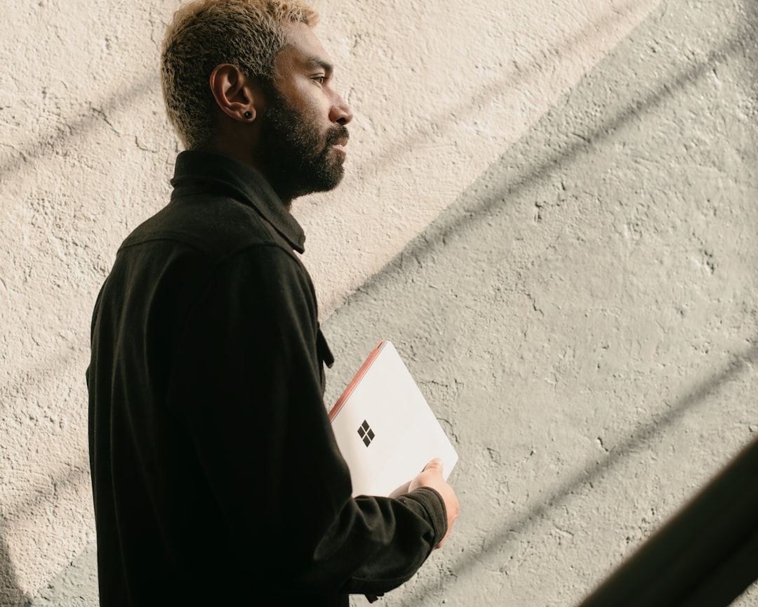 a man with a beard is holding a folder