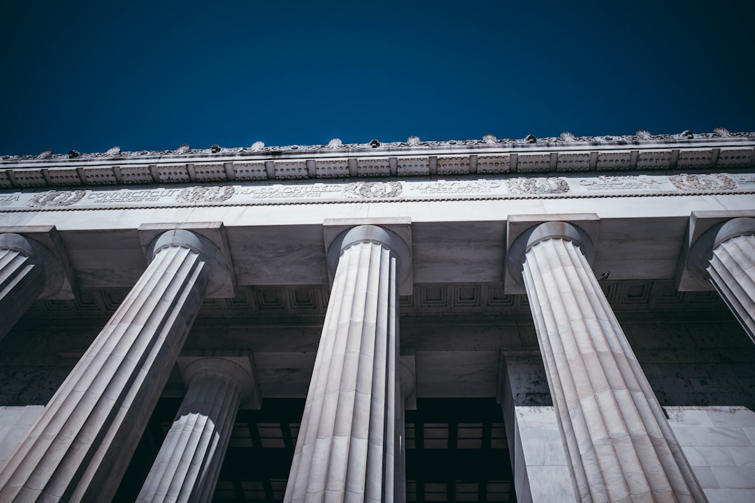 Neoclassical building facade with grand columns and blue sky
